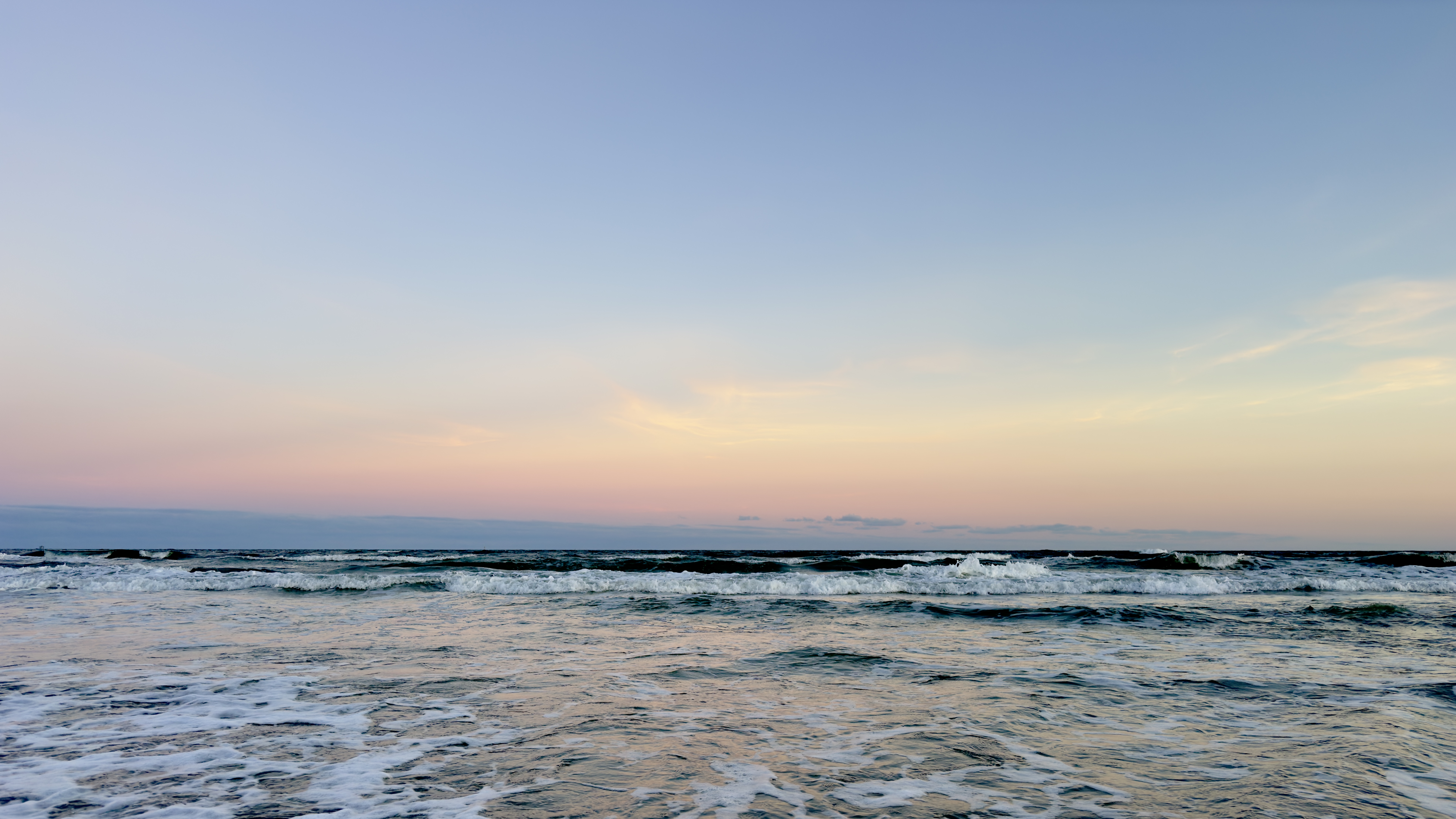 Peaceful ocean waves at sunset